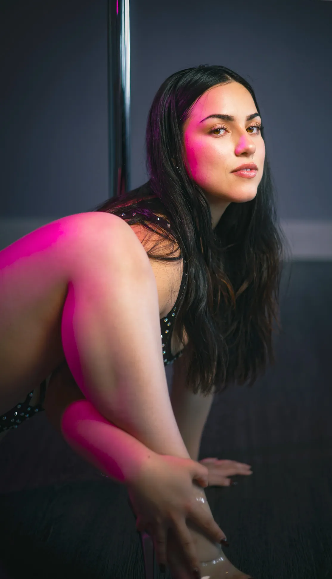 dancer posing under neon lights